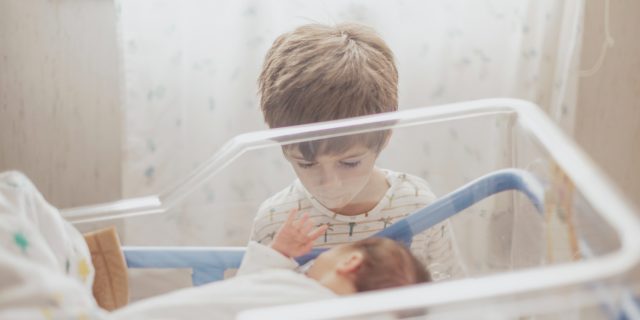 kid-watching-his-little-brother